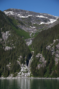 A waterfall flowing into Tracy Arm